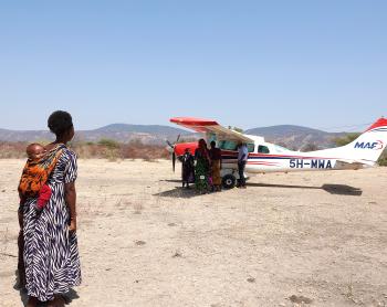 Woman looking at MAF plane in Mahaka