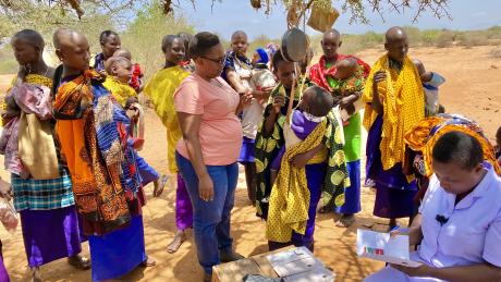 Mothers gather around waiting for the nurse to tend for their children