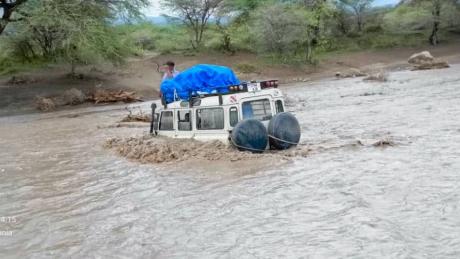Car in flooded Sanjan river needed to be pulled out with ropes and another veichle on dry land after being bogged in the muddy, flooded rivercrossing 