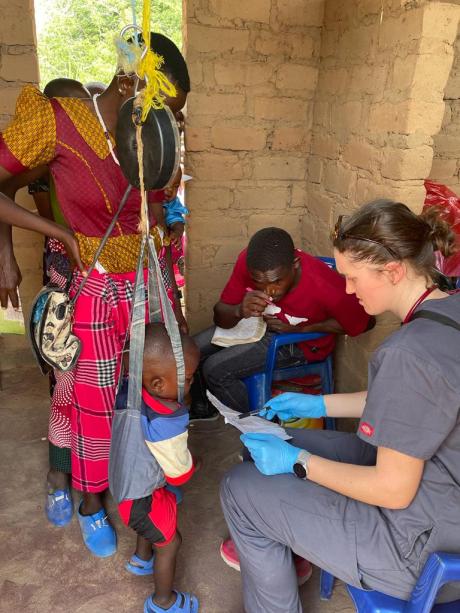 One of the nurses monitors a child's weight during the clinic.