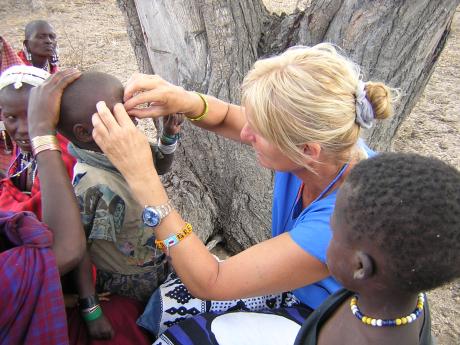 Angelika assessing a child's eye in a remote village.
