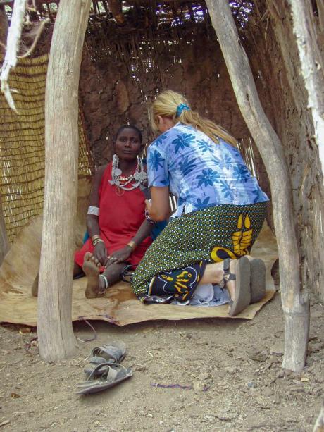 Angelika assesses a pregnant woman during a medical camp at a remote village.