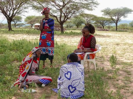 Magdalena consulting with the women on maternal health issues