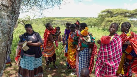 Mothers with their children, patiently await their turn to monitor their babies.