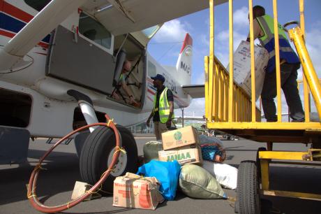MAF staff loading the school supplies in the plane