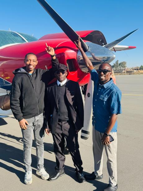Some team members in front of MAF plane