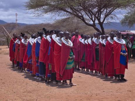 Maasai arrayed in colourful clothing, ready to welcome visitors